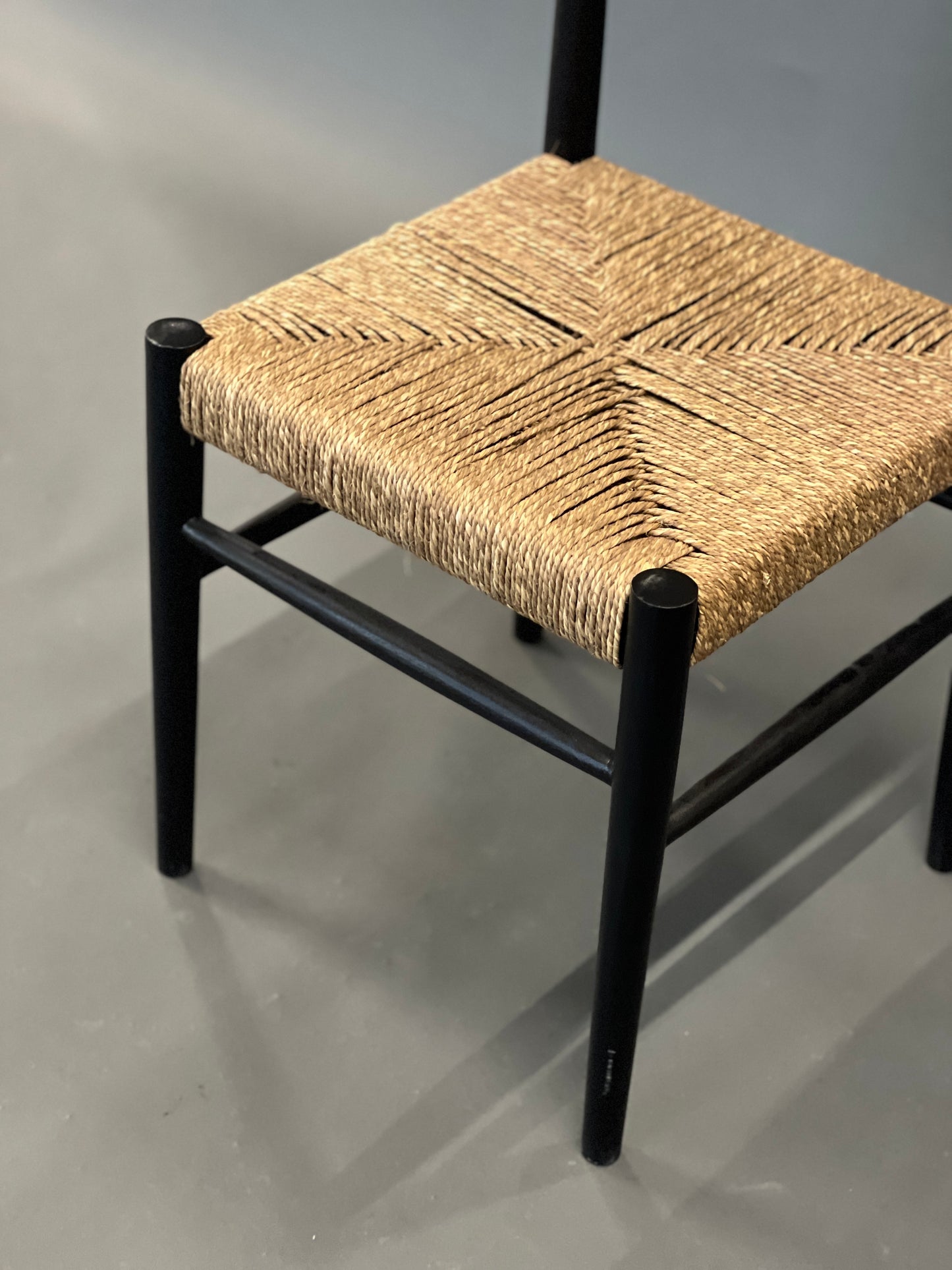 Dining chair with black frame and natural rope