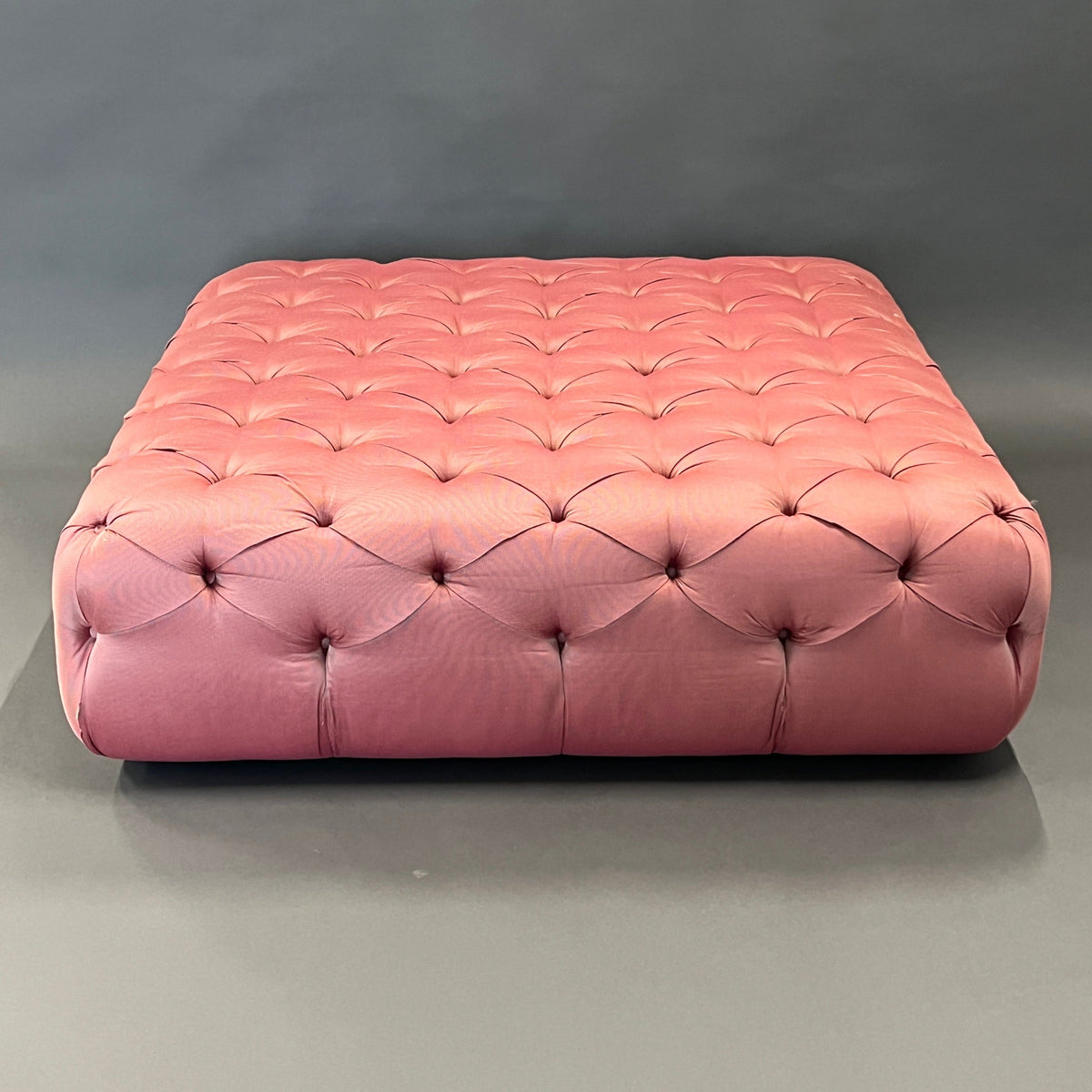 Pouf / Ottoman made of pink fabric