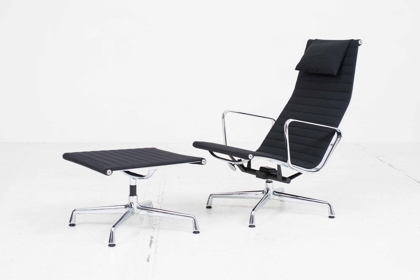 Vitra EA 124 armchair and EA 125 ottoman by Charles and Ray Eames in black Hopsak