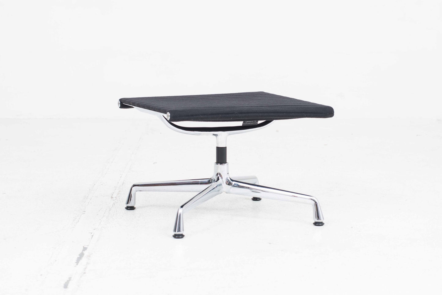 Vitra EA 124 armchair and EA 125 ottoman by Charles and Ray Eames in black Hopsak