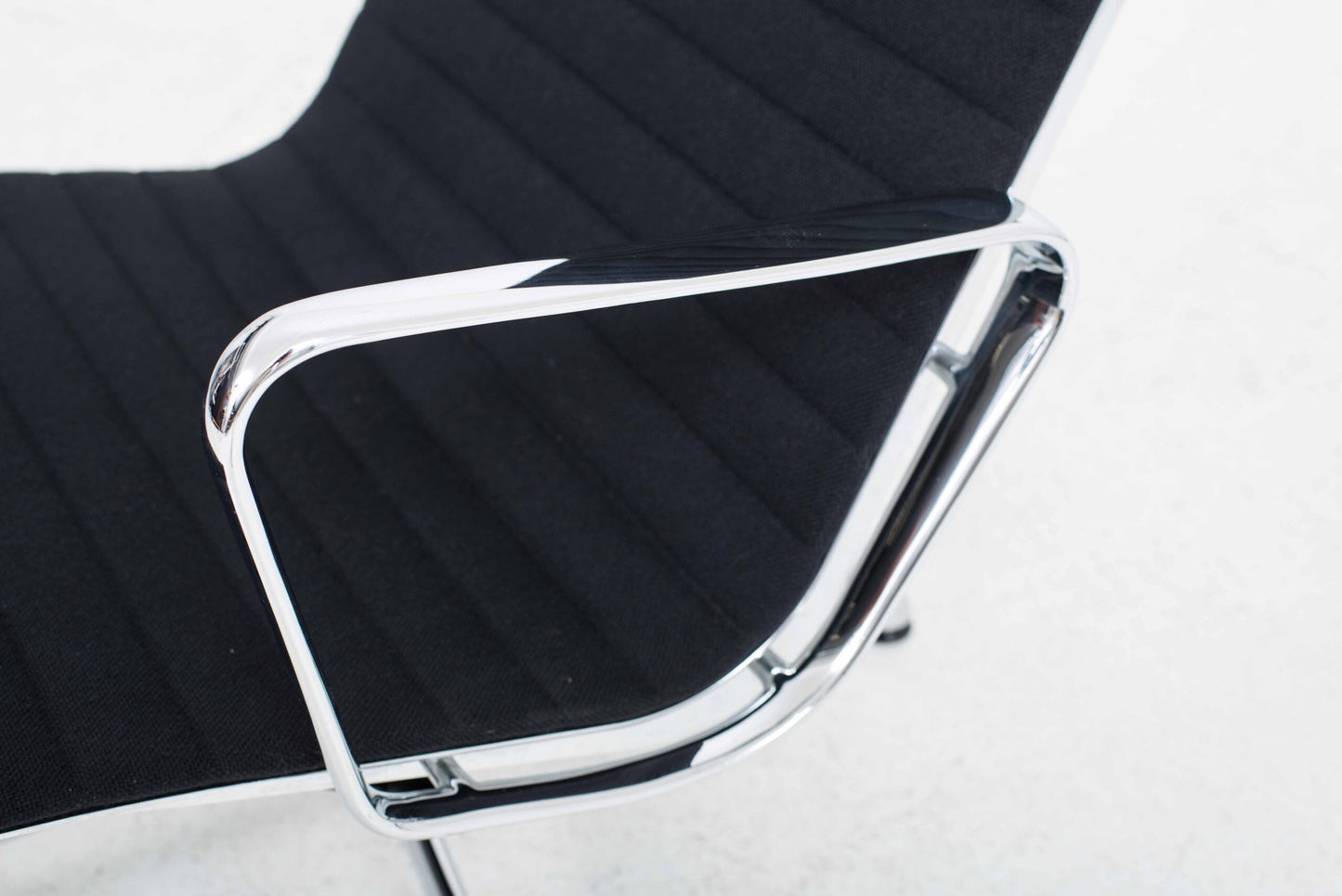 Vitra EA 124 armchair and EA 125 ottoman by Charles and Ray Eames in black Hopsak