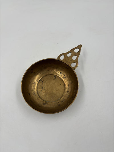 Vintage brass bowl with handle and perforated pattern